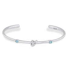 Load image into Gallery viewer, Love Knot Bracelet with White Topaz | Aquamarine  This simple design is handcrafted with Sterling Silver to convey the message of eternal love.  Sterling Silver   White Topaz: 2.5mm  Aquamarine: 2.5mm